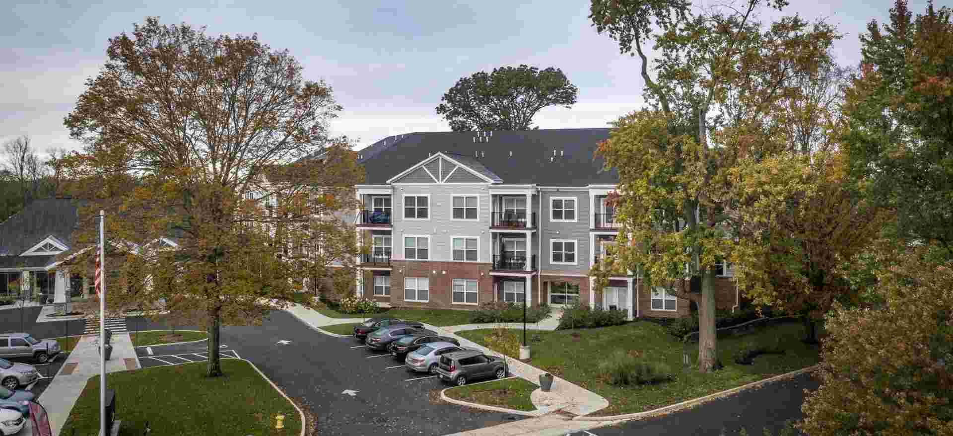 Exterior photo of Legacy Village apartments on a fall day