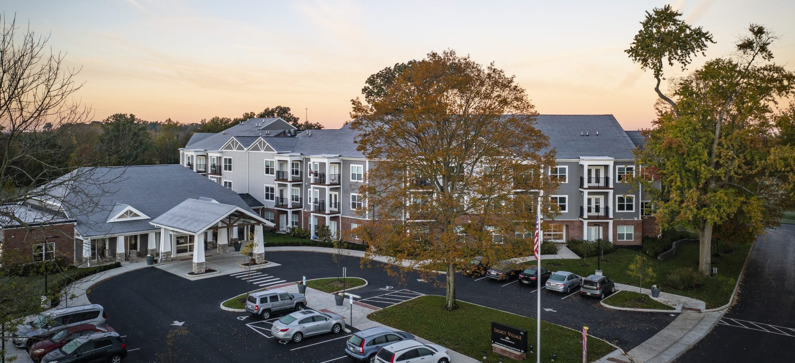 Legacy Village apartments and parking lot on a fall day