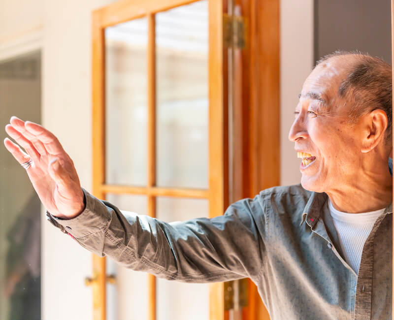 elderly man waving