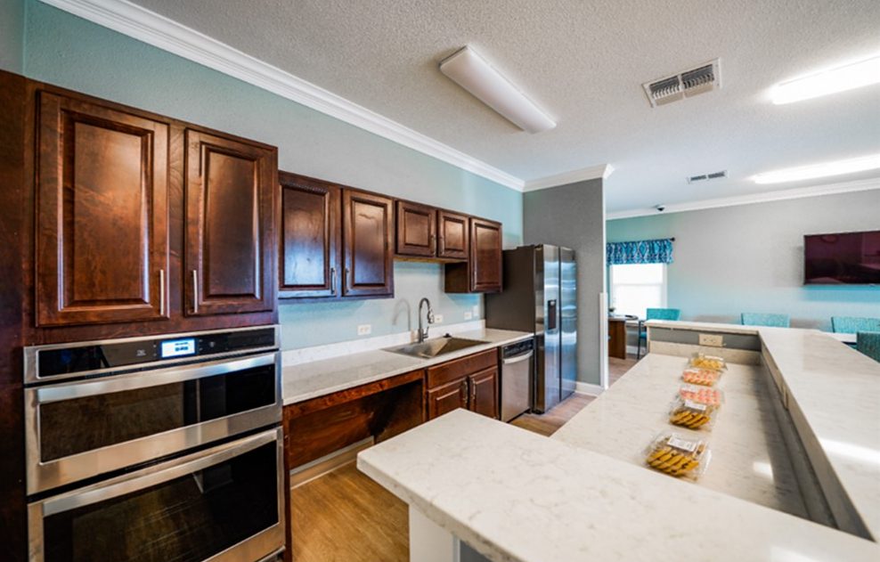 Community kitchen area with cookies on marble countertop at Mid-Tule