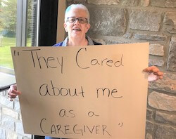 Deb holding up a they care sign