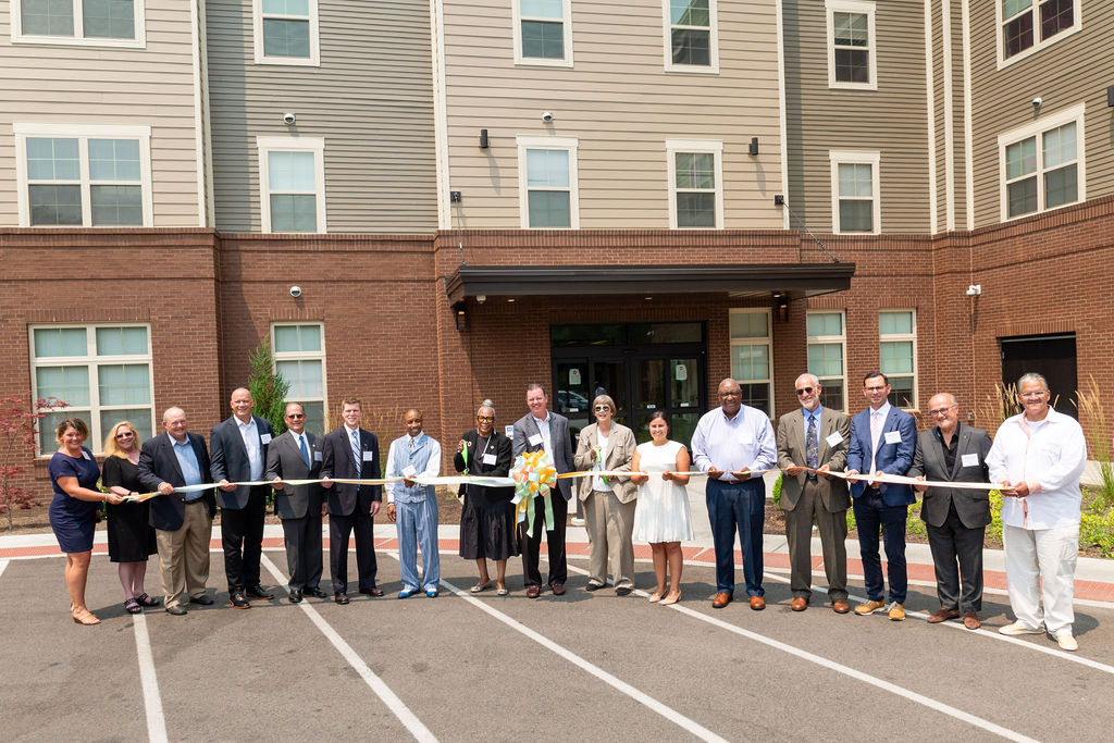 National Church Residences cutting a ribbon for the celebration for the grand opening of the Commons at South Cumminsville.