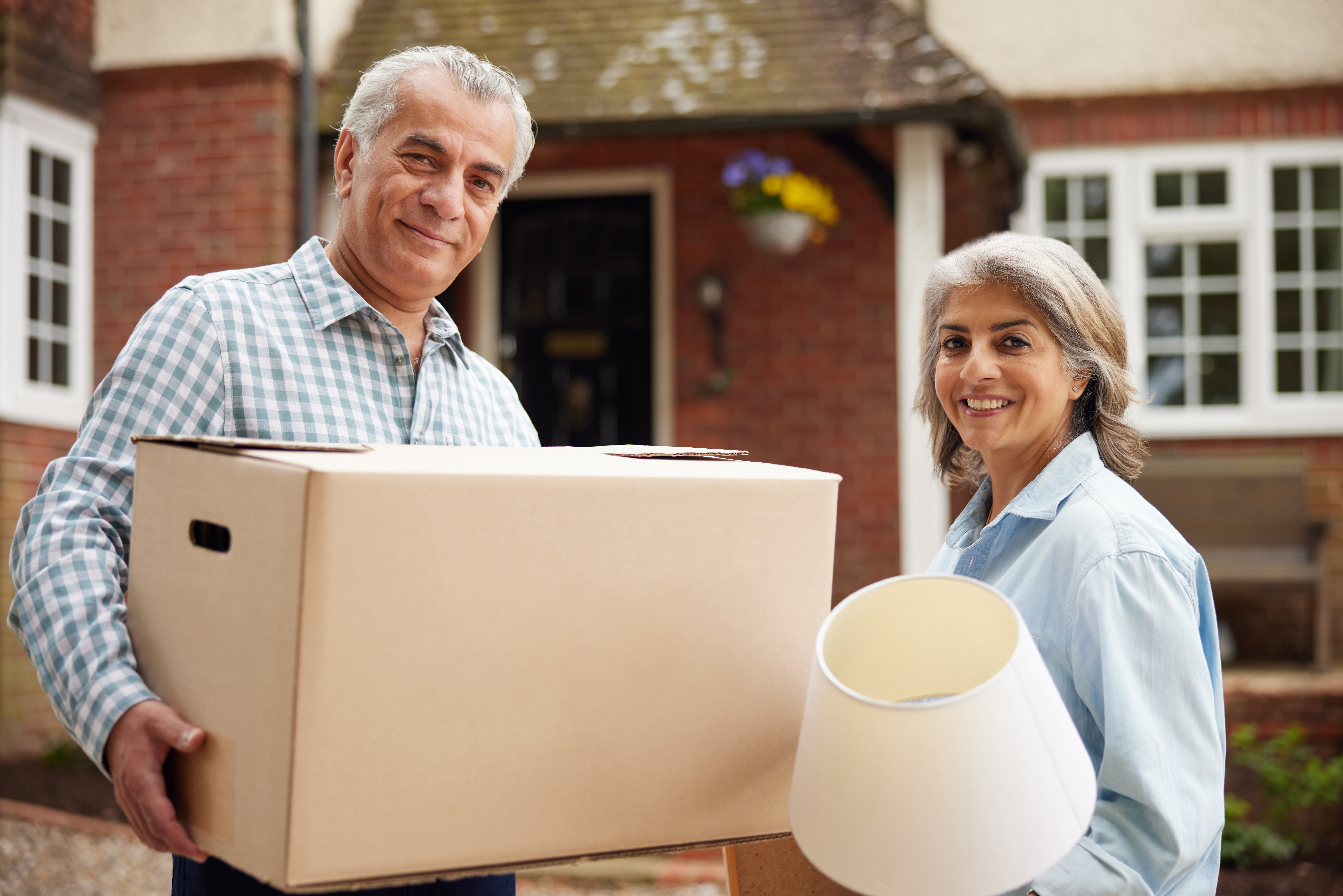 A couple moving out after taking advantage of downsizing help for seniors.