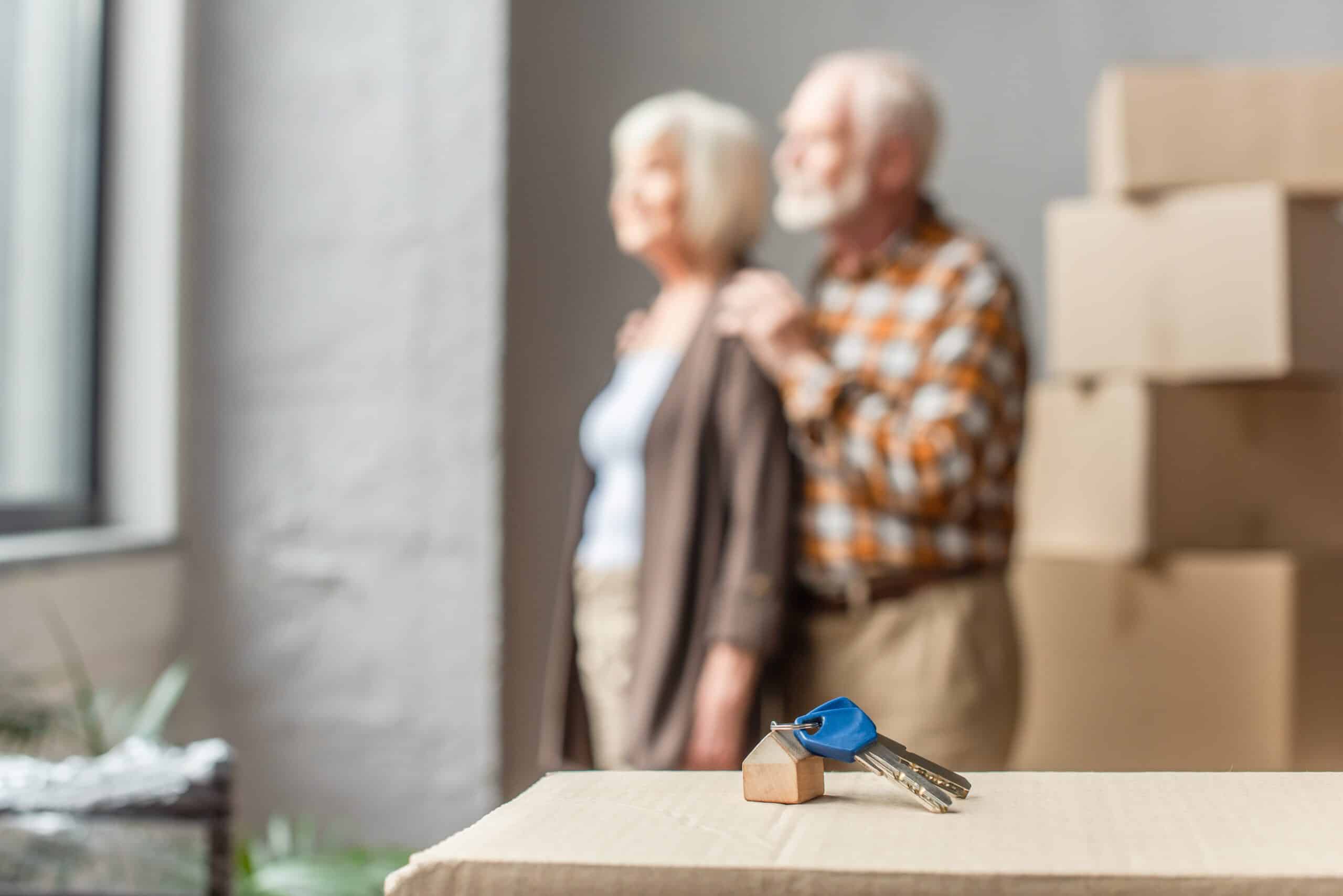 A senior couplepacking up in their house after using a checklist for moving elderly parents.