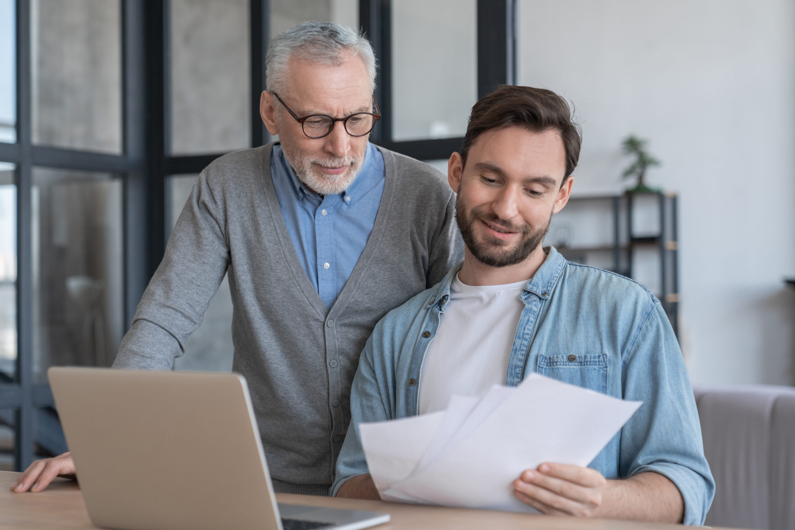 An adult caregiver going over a checklist for taking over his parents’ finances.