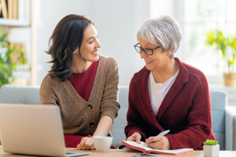 An adult caregiver talking to her aging parent about finances.