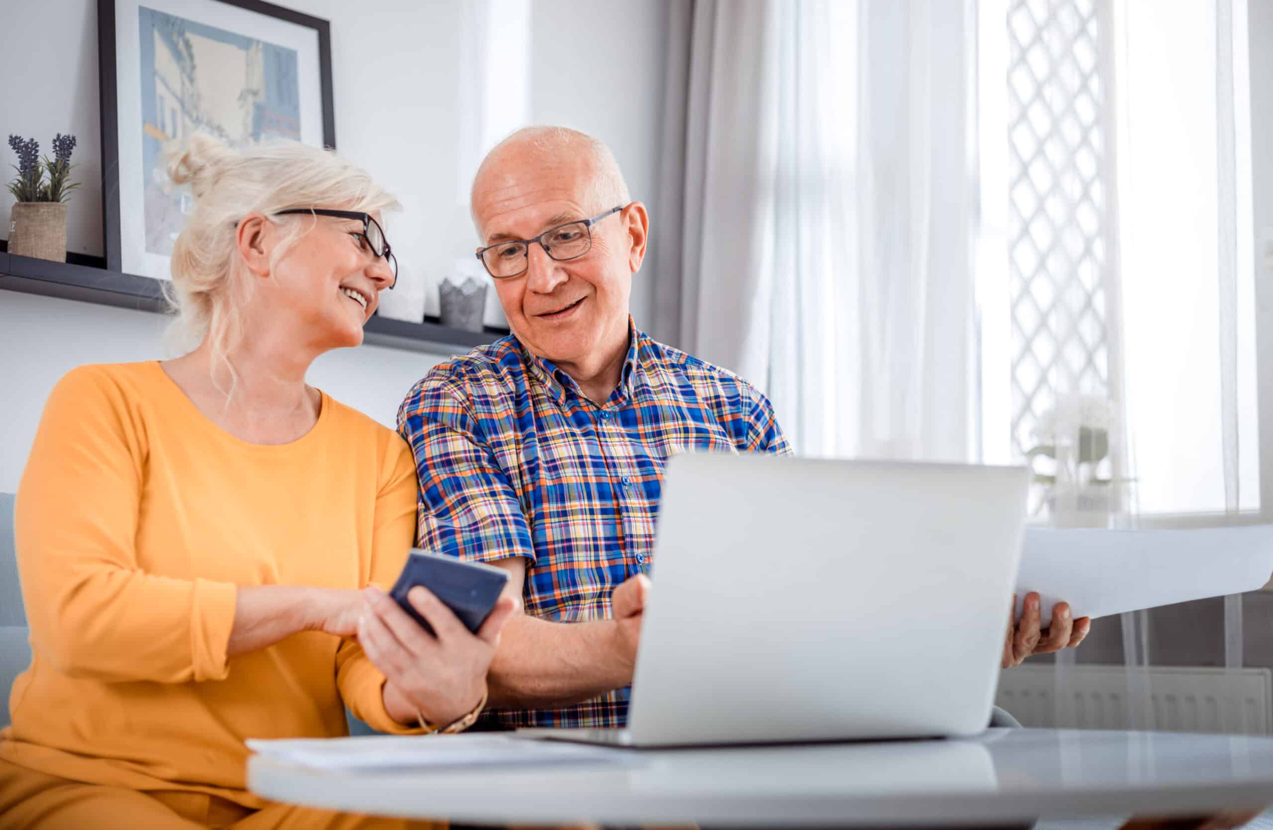 A senior couple researching how to pay for assisted living.