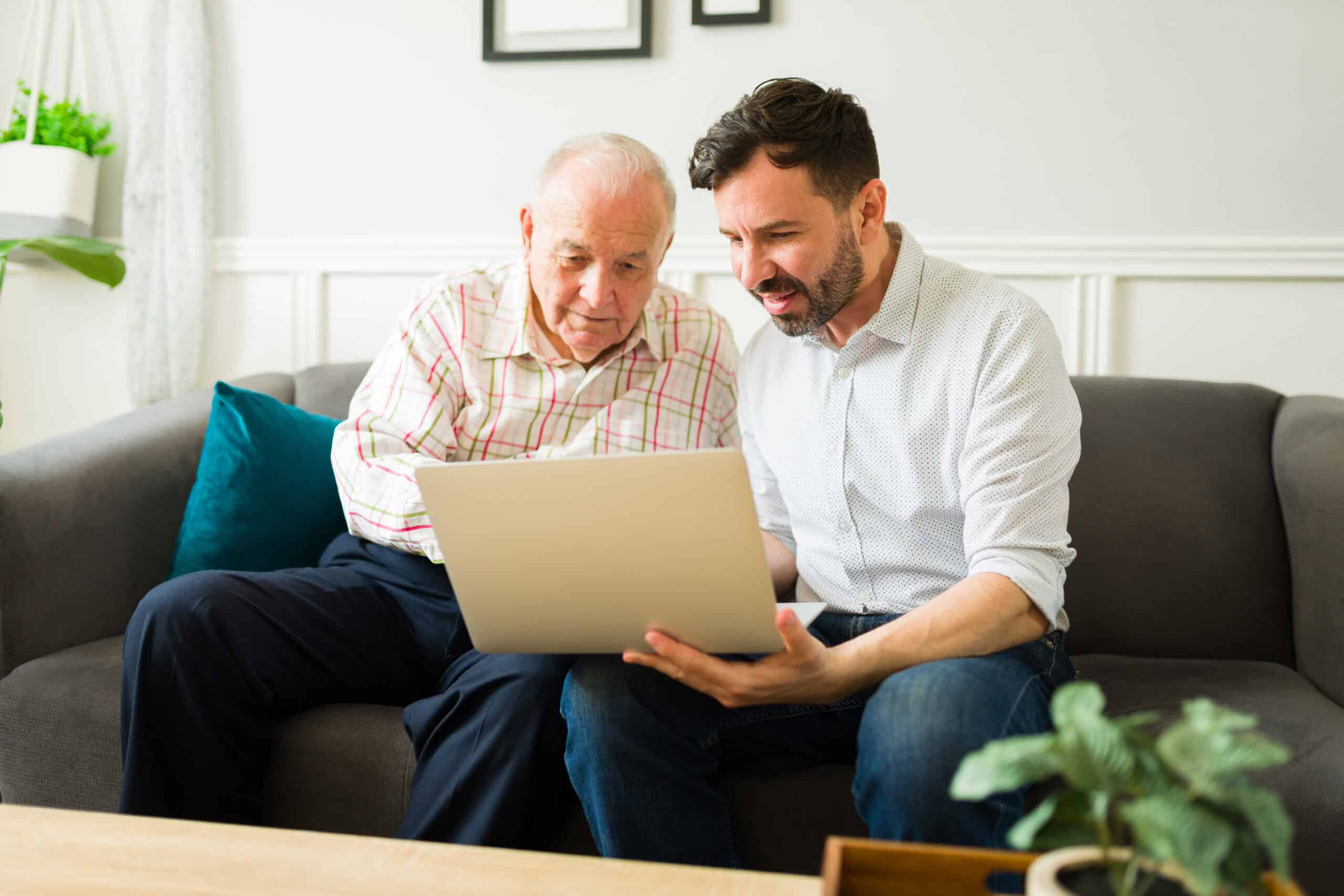 An older man and his son comparing assisted living vs nursing homes.