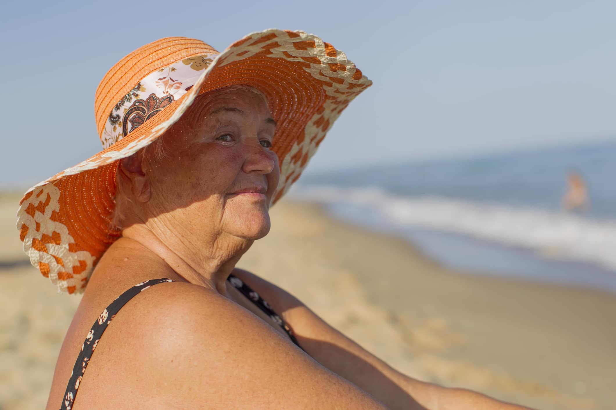 A happy older woman staying safe after learning hot weather tips for seniors.