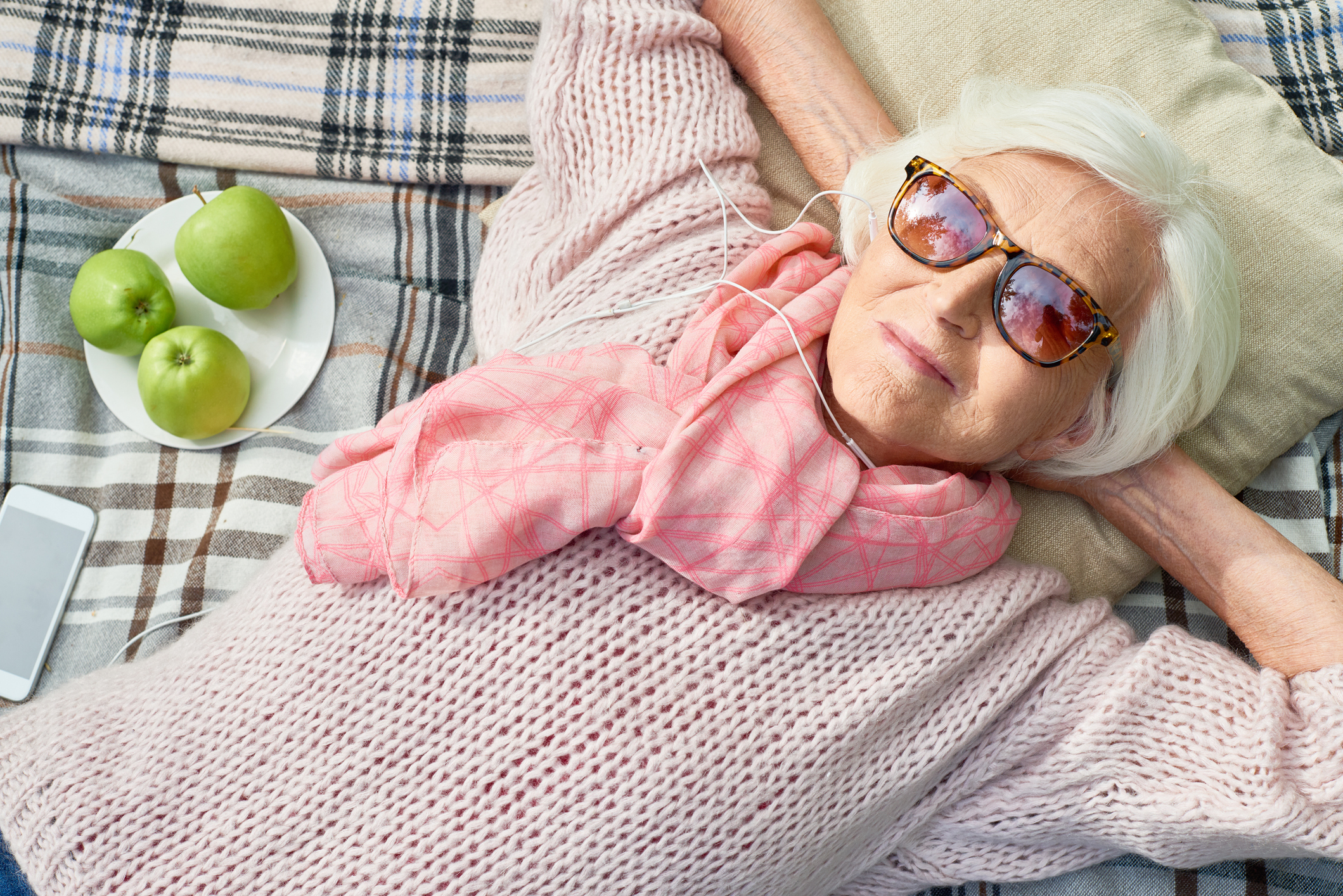 An older woman practicing sun safety for seniors.