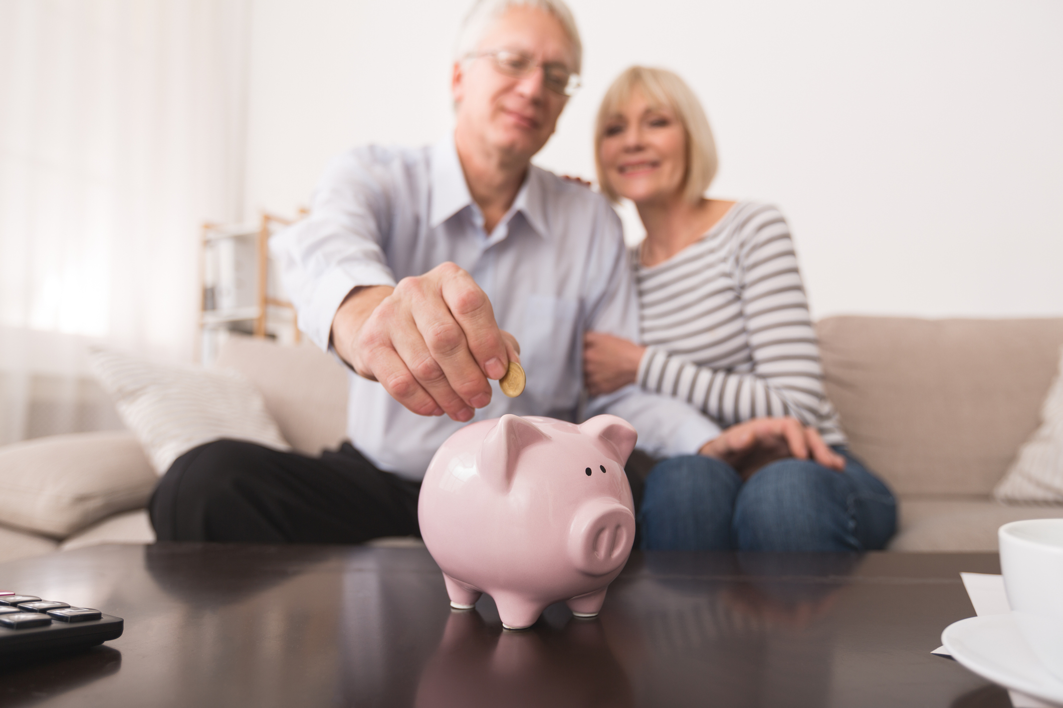 A senior couple saving money after maximizing their social security benefits.