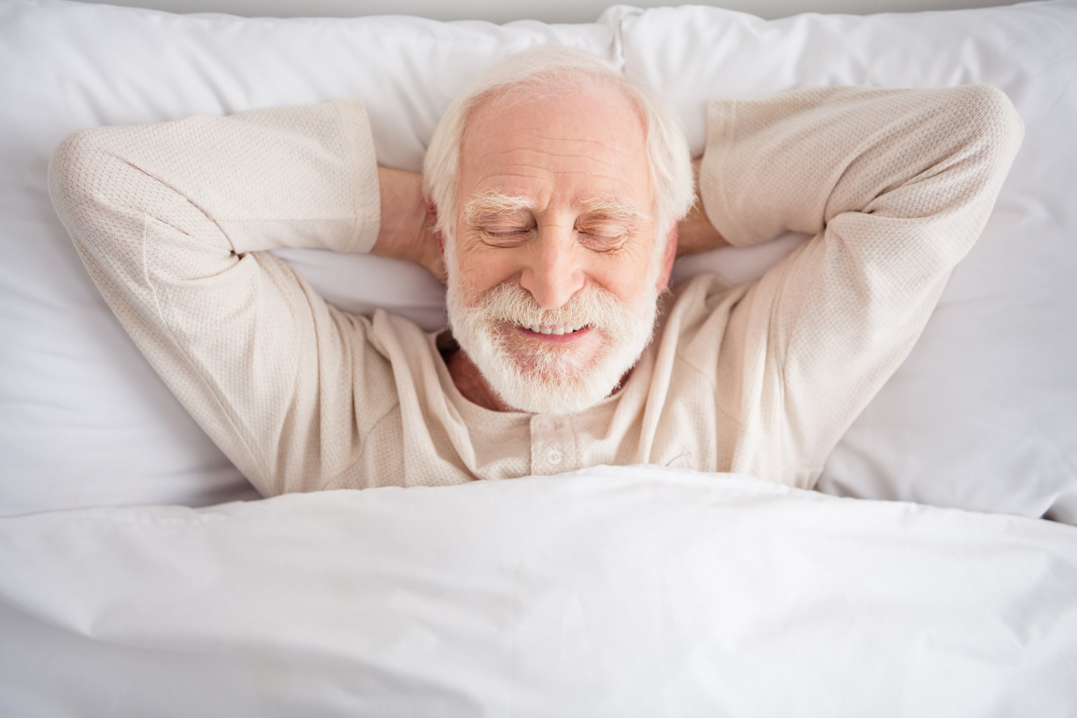 A elderly man resting in peace after reading about sleep tips for seniors.