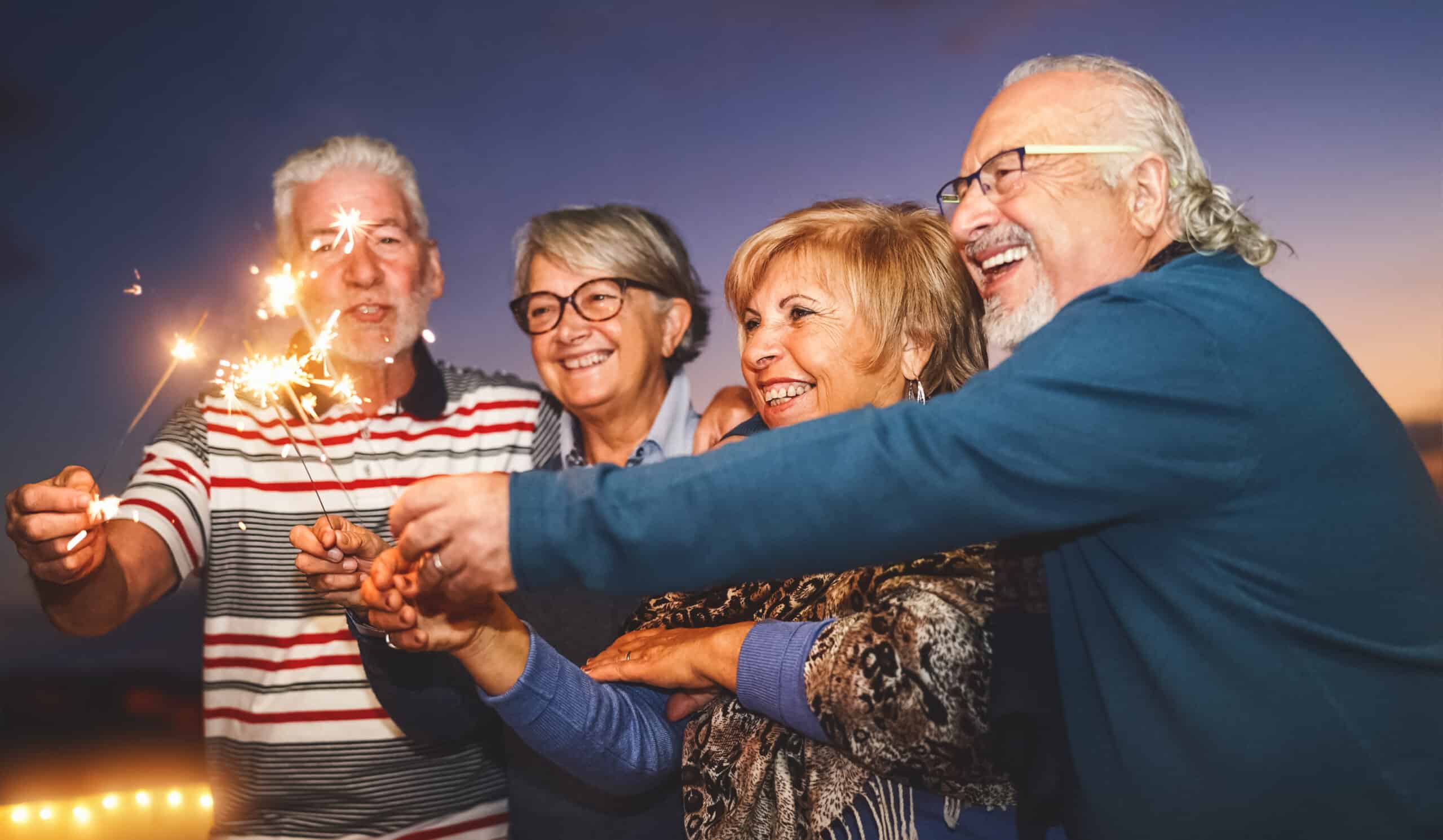 A group of seniors lighting sparklers as they celebrate New Year’s Eve.