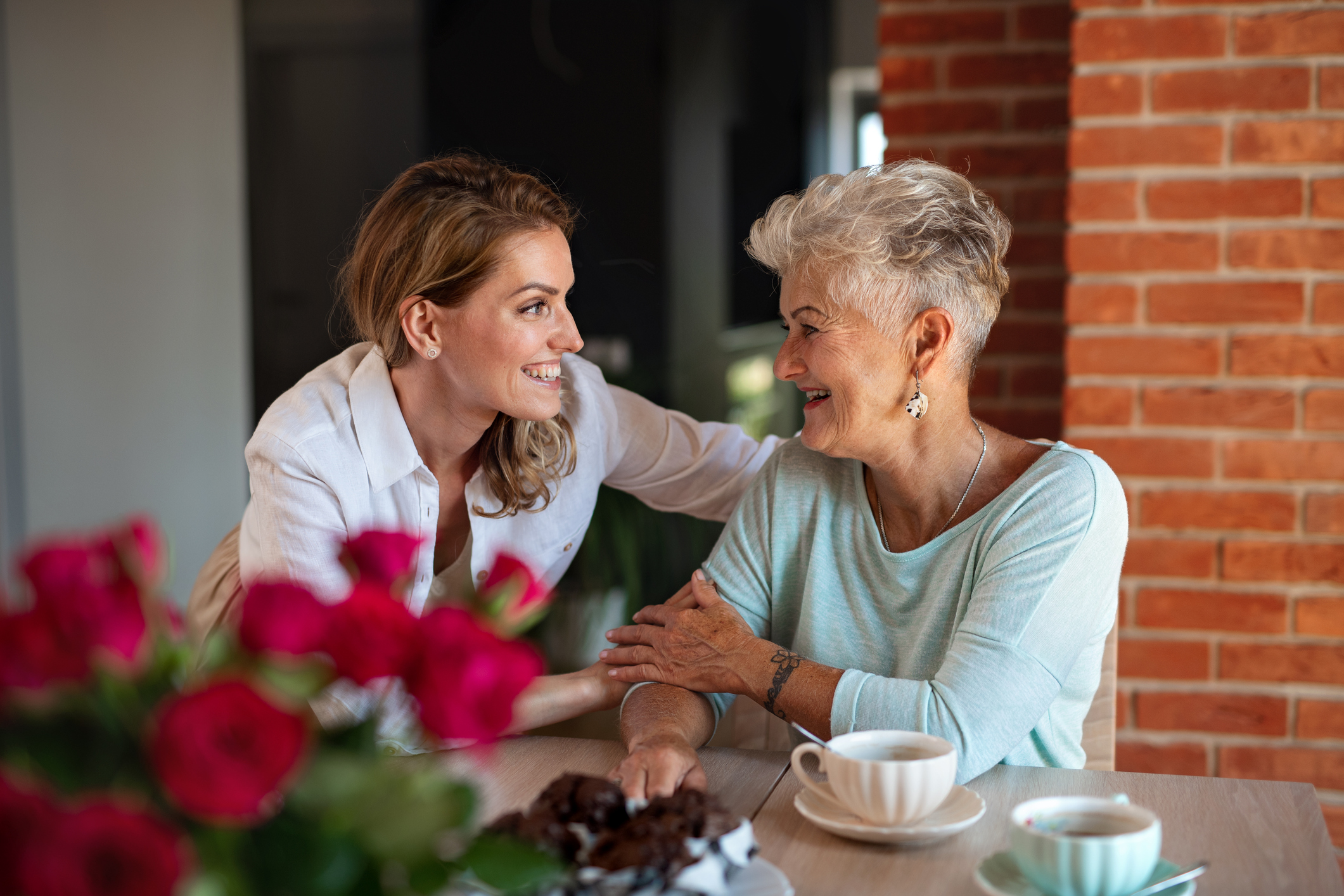 A daughter and her elderly mother discussing the role reversal from daughter to caregiver.