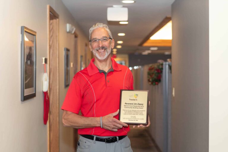 Man holding award in hallway