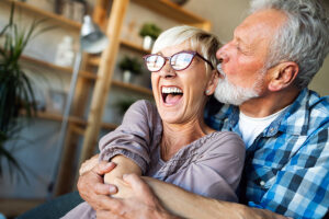 Senior woman and man laughing, enjoying independent living together