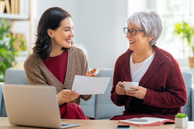 A senior woman discussing critical healthcare information with her daughter.