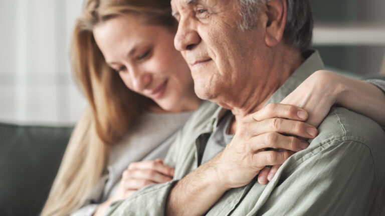 Loved ones hugging, recognizing the early signs of Alzheimer's and seeking support for caregivers of Alzheimer's