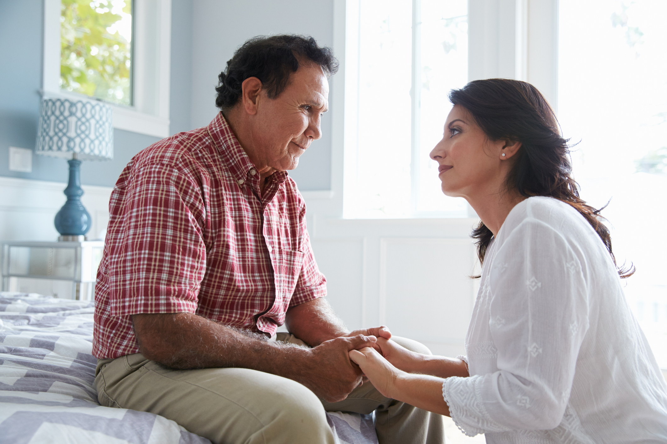 An adult talking to their parent about memory care.
