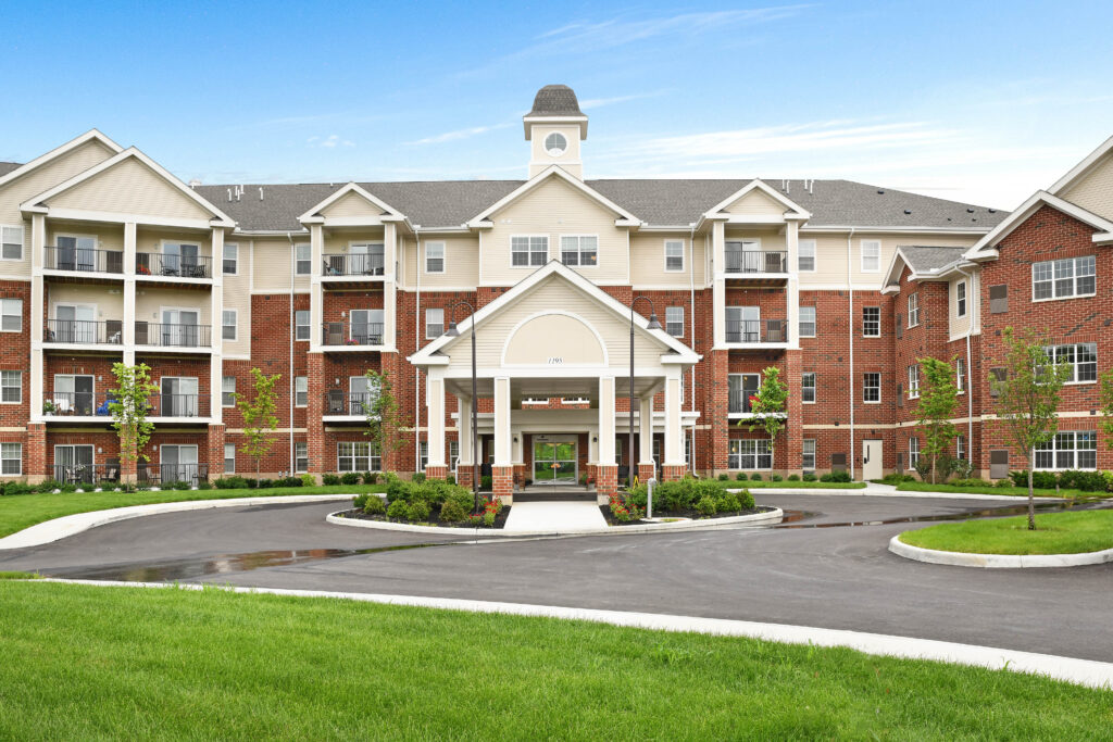 Exterior of a large brick and stone senior living community building