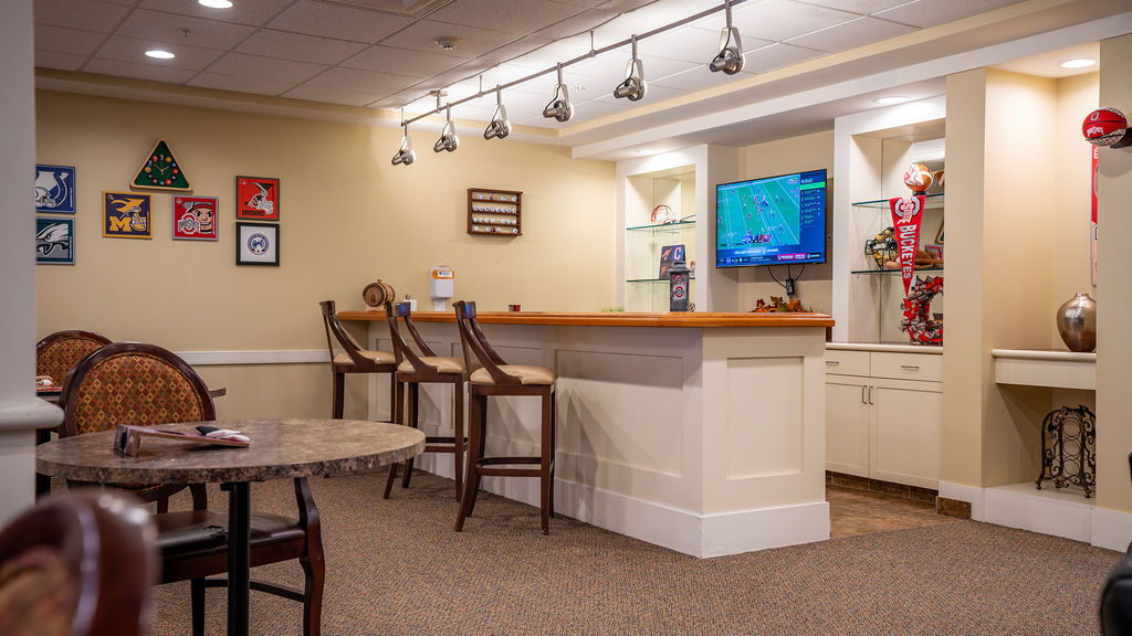 Bar area with bar stools and sports memorabilia