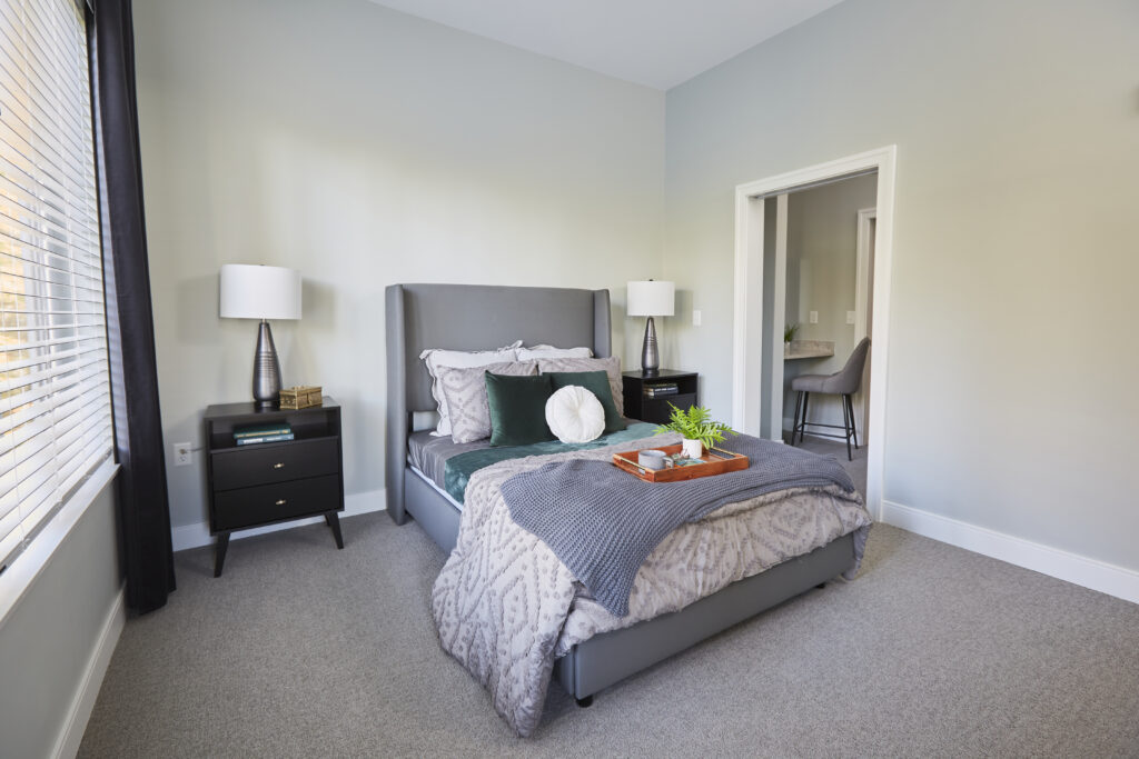 Modern bedroom with gray bed and nightstands