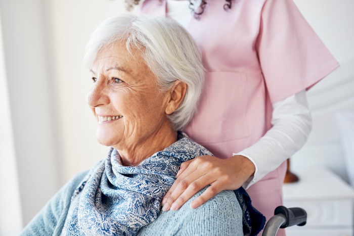 senior woman in wheelchair with nurse