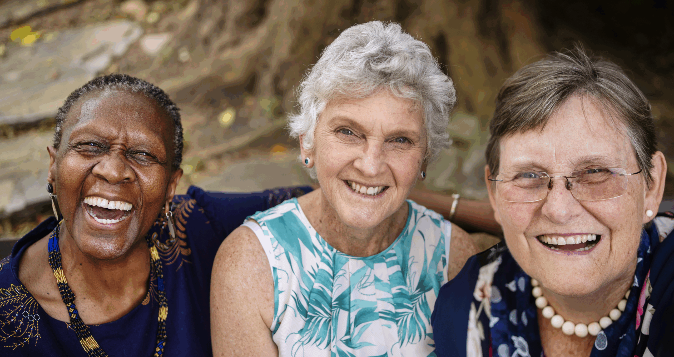 three senior woman sitting and smiling
