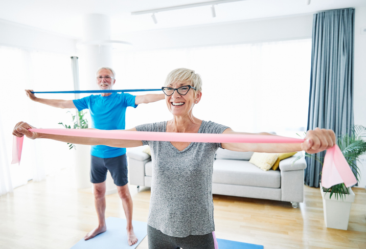 Senior couple exercising with resistance bands