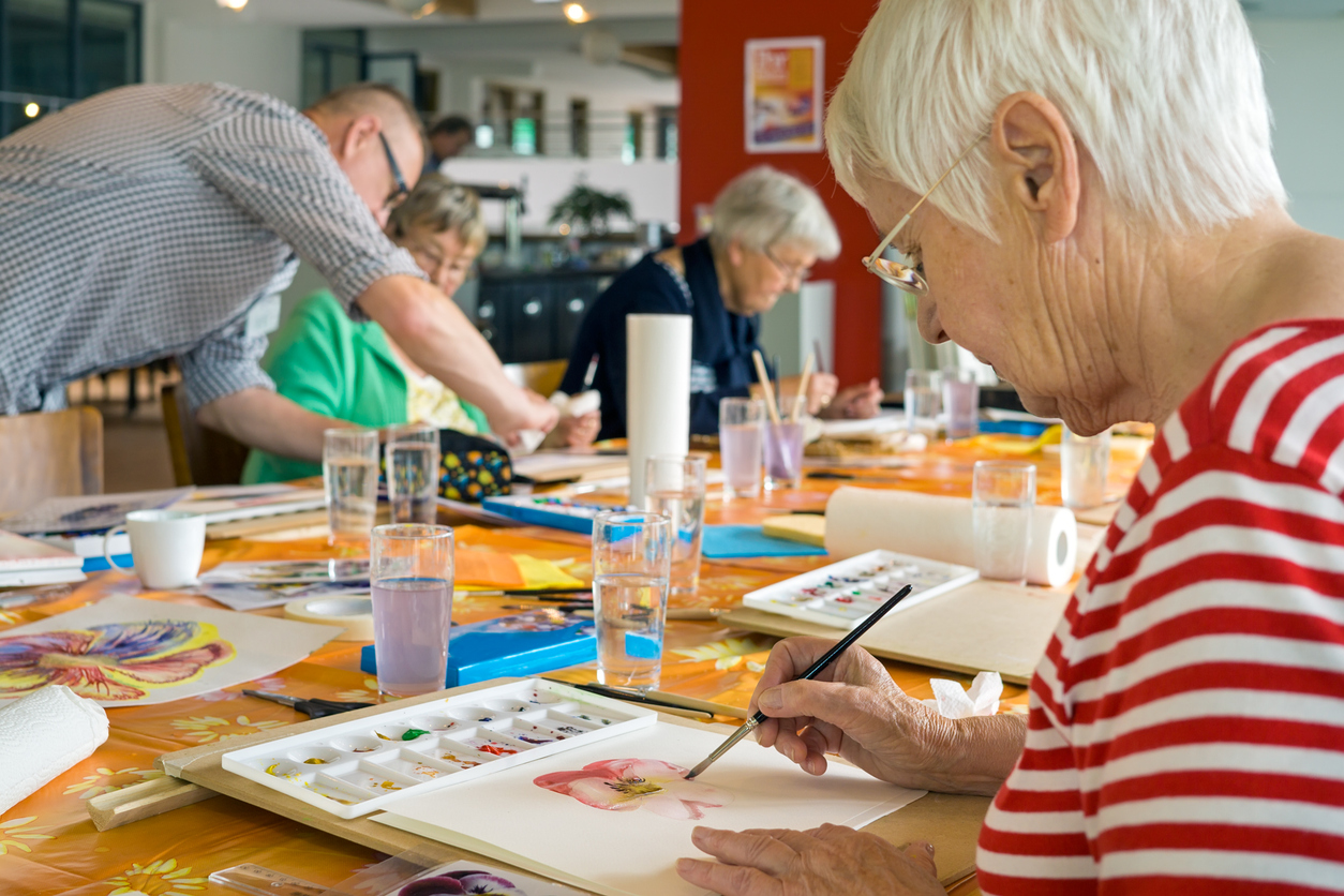 Seniors painting with watercolors in an art class