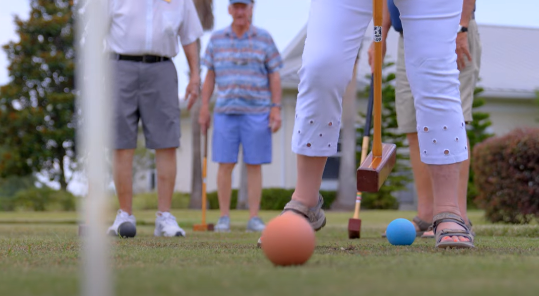 Seniors playing croquet
