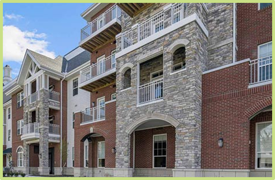 Modern senior living building with stone and brick