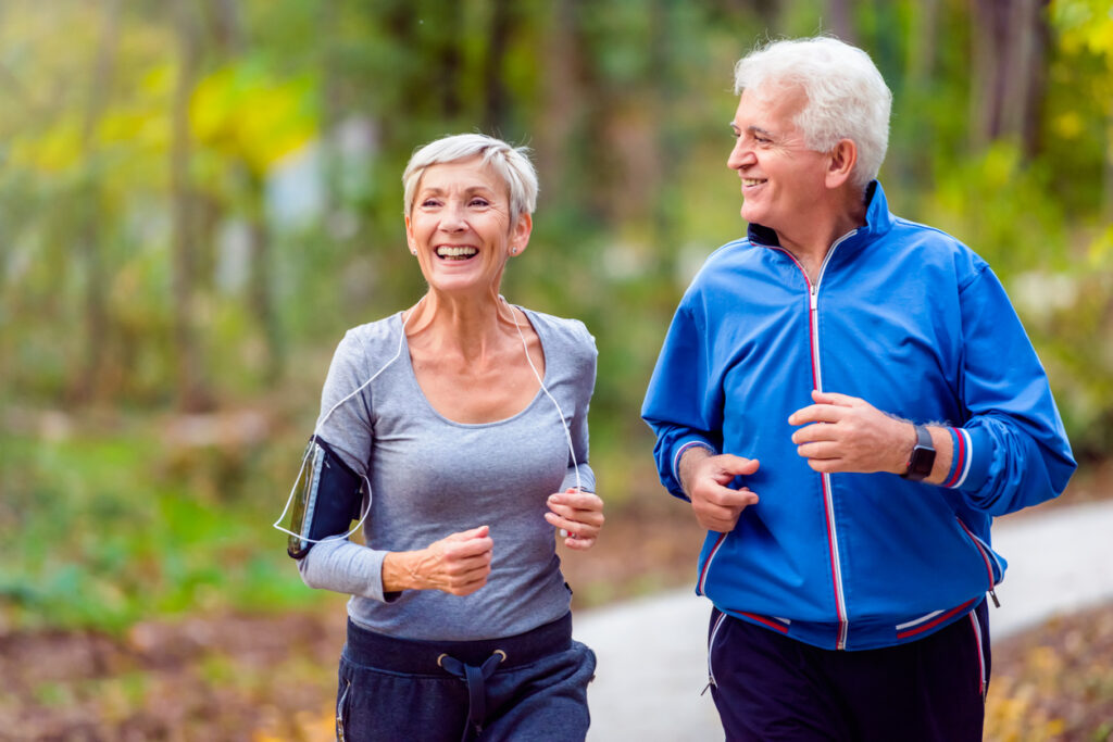 Senior couple jogging on a path in a park