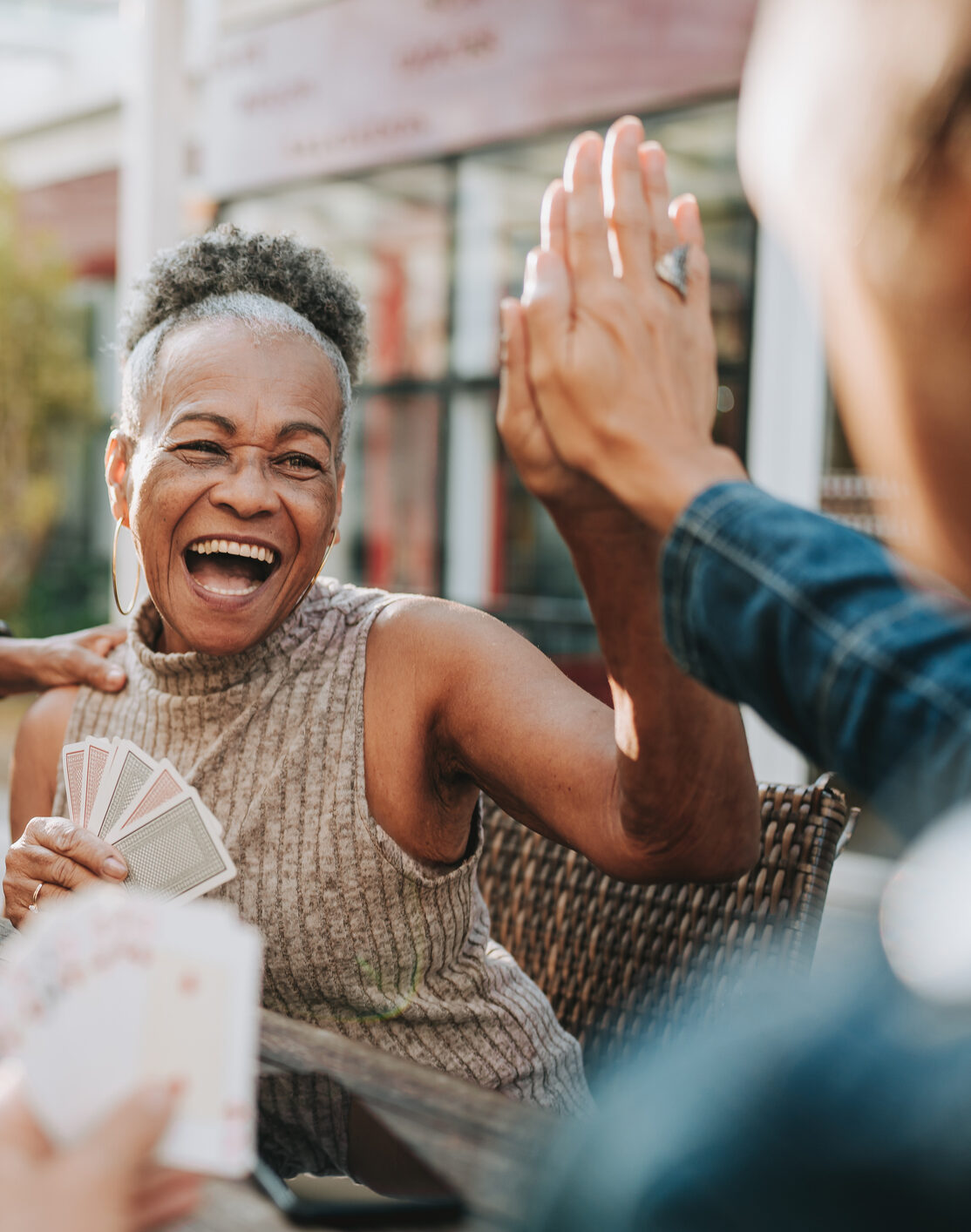 Senior women friends playing cards