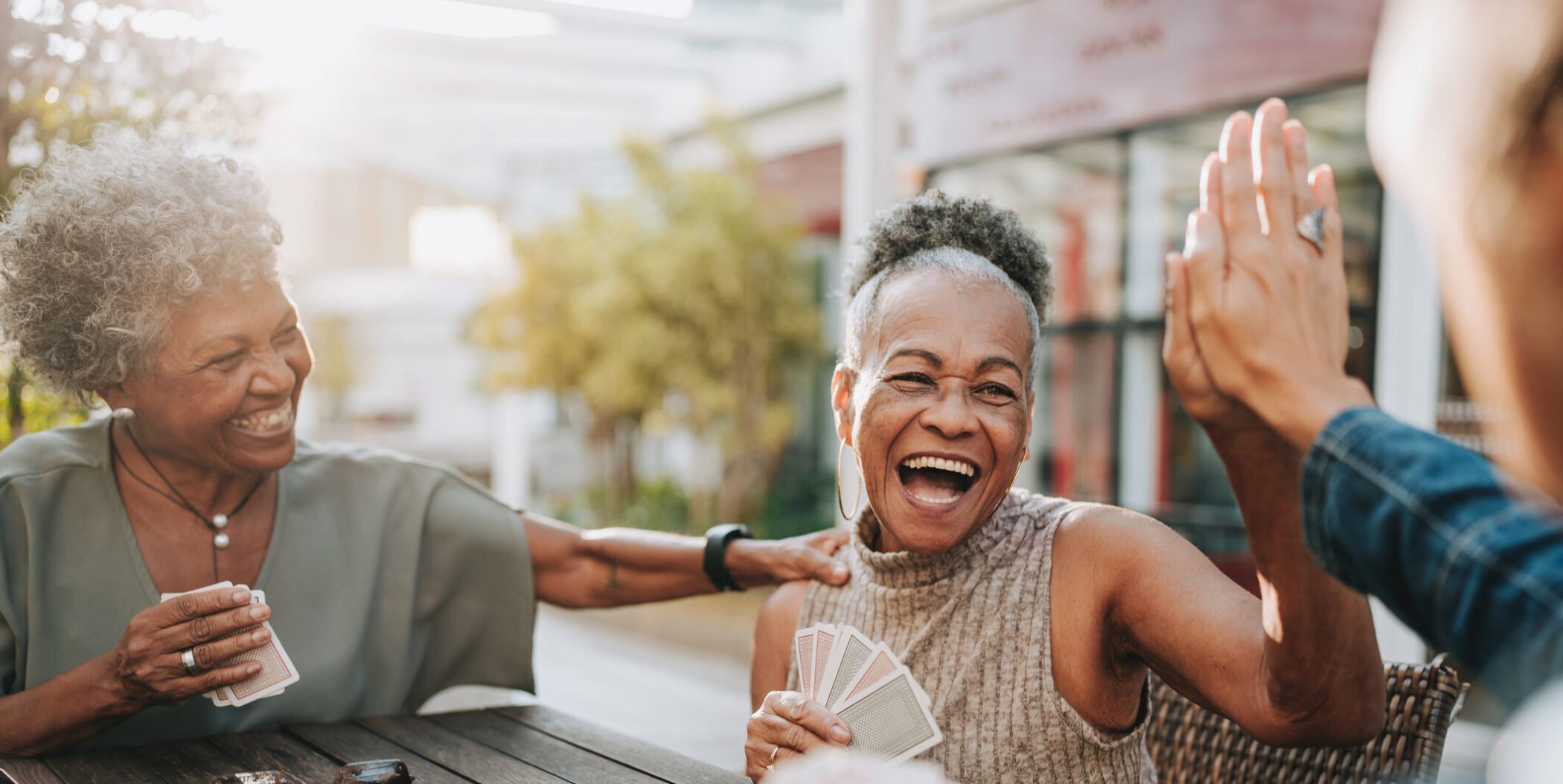 Senior women friends playing cards
