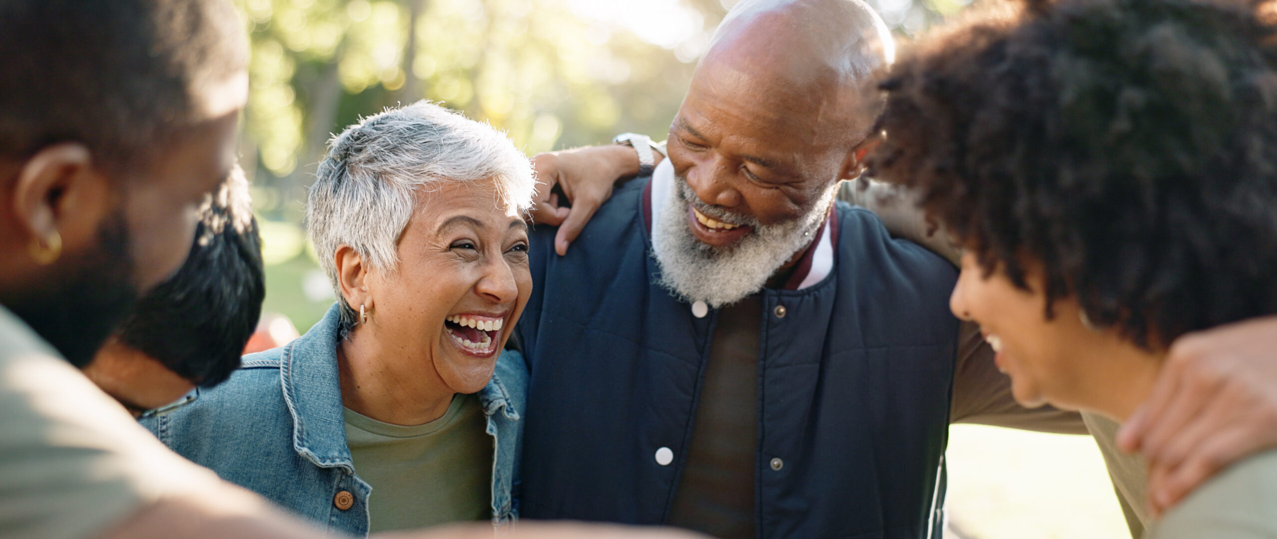 Senior couple smiling and talking in a bright, modern living room