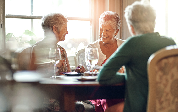 Senior women, friends and smile in restaurant for wine, vacation and retirement together with happy. Elderly people, reunion and relax in diner for drinks, holiday and social celebration with memory