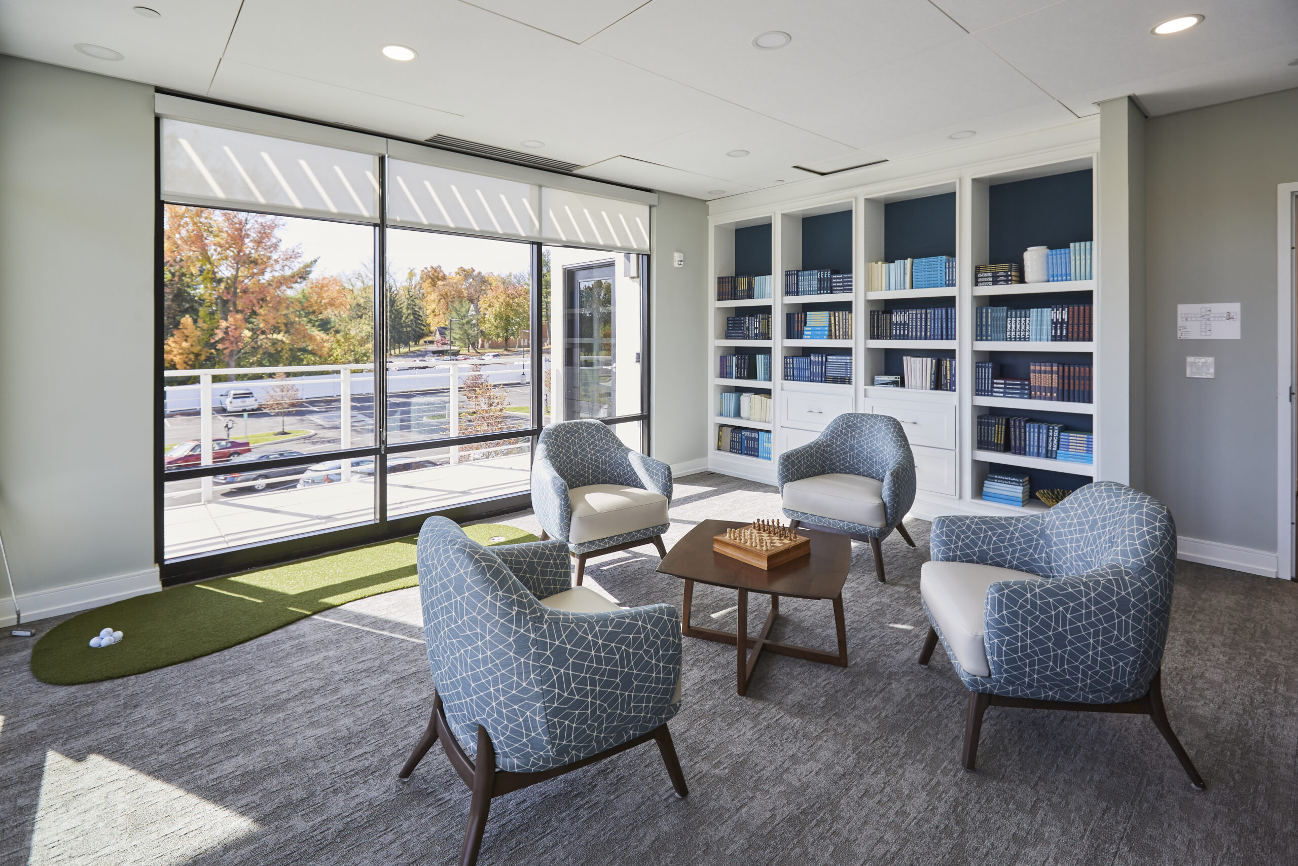 Community lounge with bookshelves and chairs