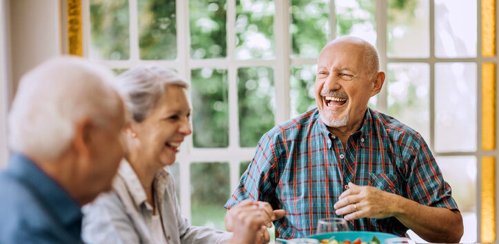 Elderly residents sharing a meal together in the dining hall