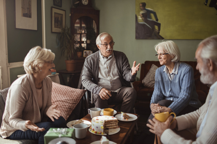 seniors gathered around a couch in conversation