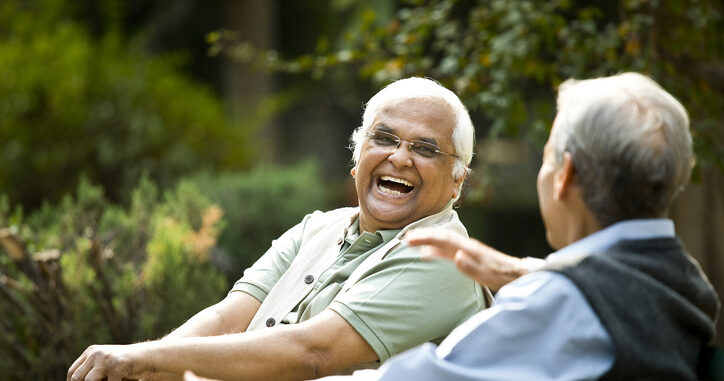 Seniors laughing on bench