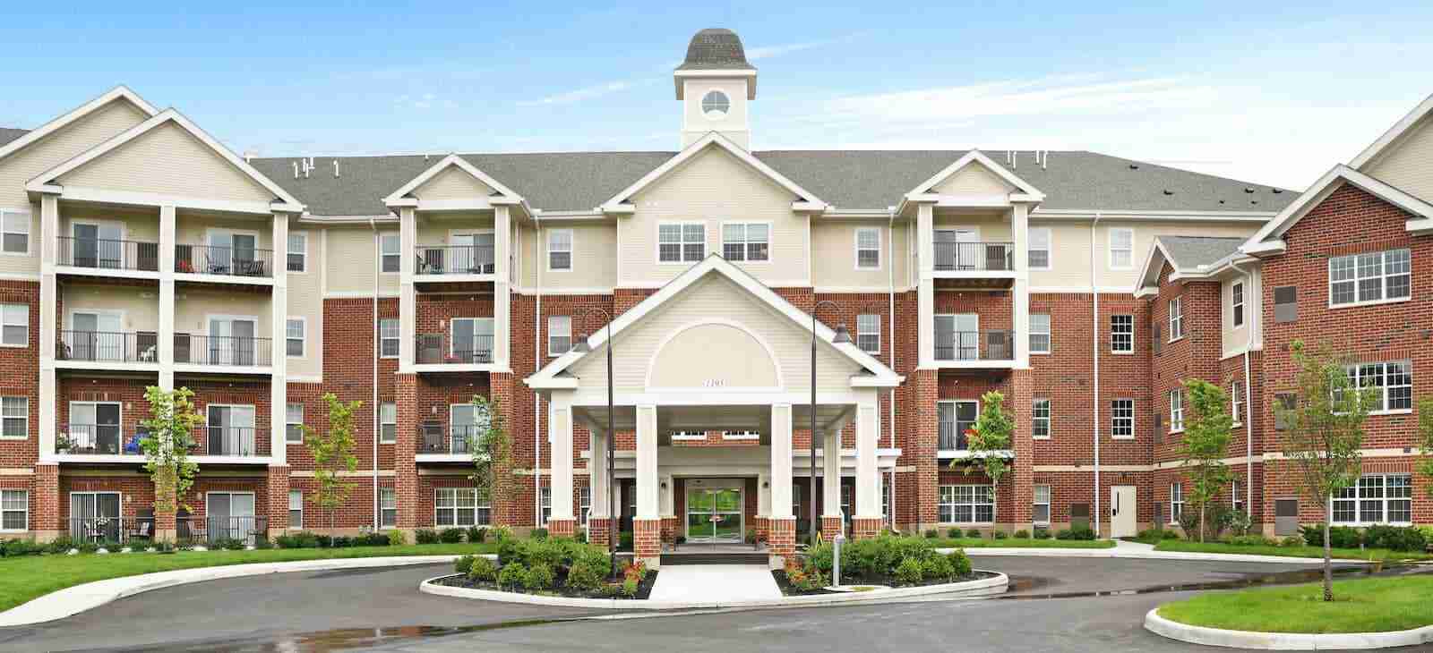 Exterior of a large brick and stone senior living community building