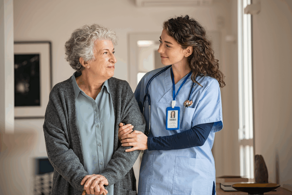 Nurse supporting older woman