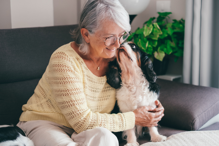 Senior woman with her pet dog at the pet-friendly Brookwood Point