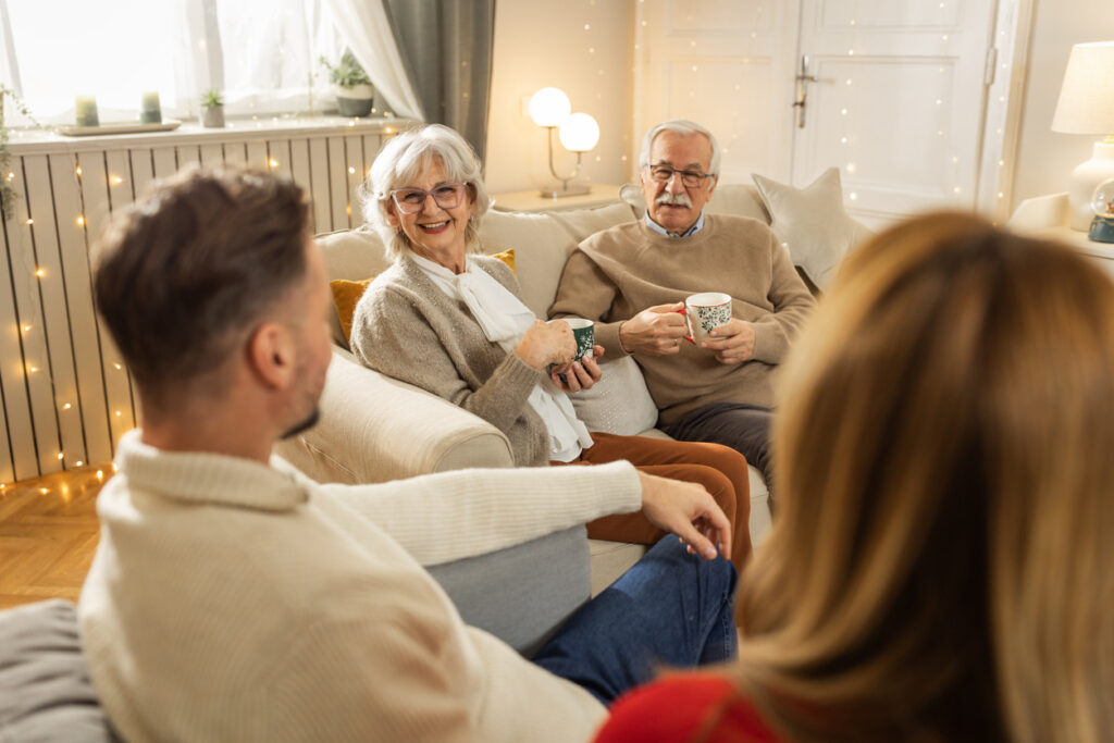 Seniors visiting with family in their apartment