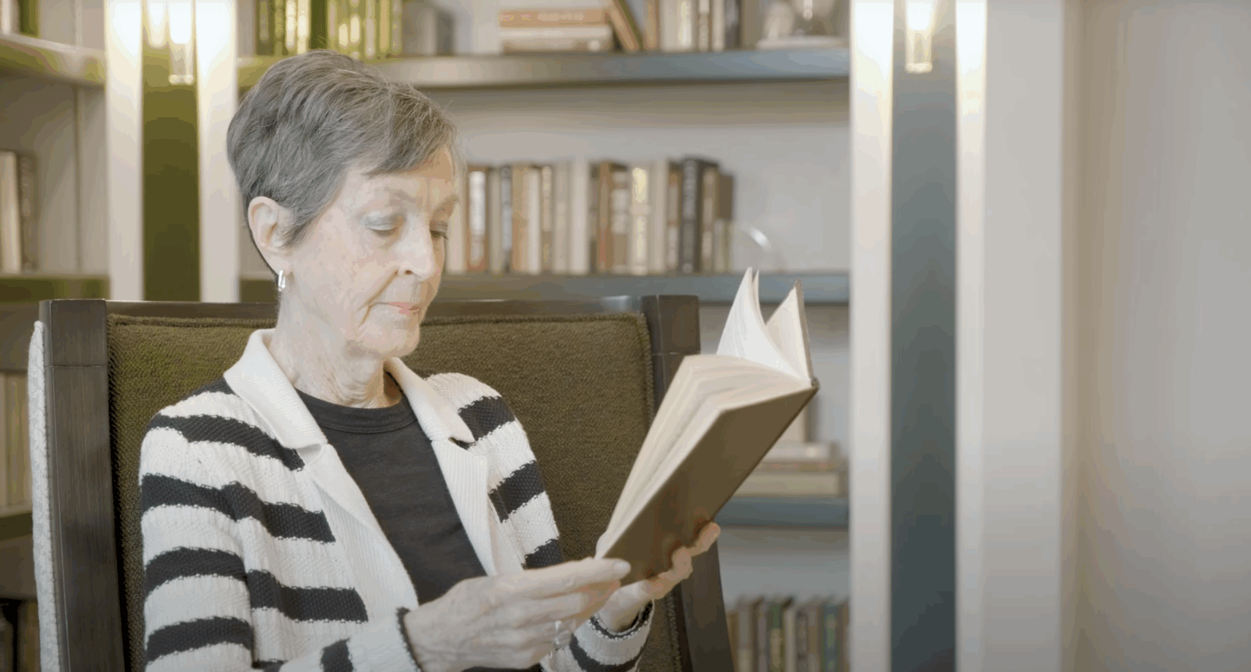 Image of Jan, a Brookwood Resident, reading a book