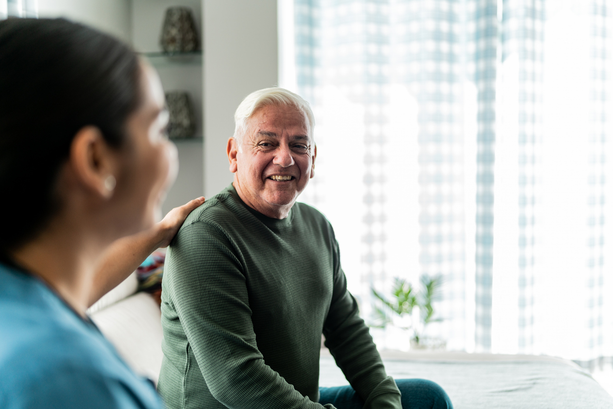 Caregiver helping a senior woman with her physical therapy exercises