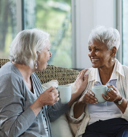 Two senior woman talking over coffee