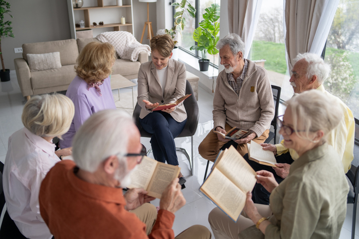 Seniors in a book club or spiritual discussion at Brookwood Point