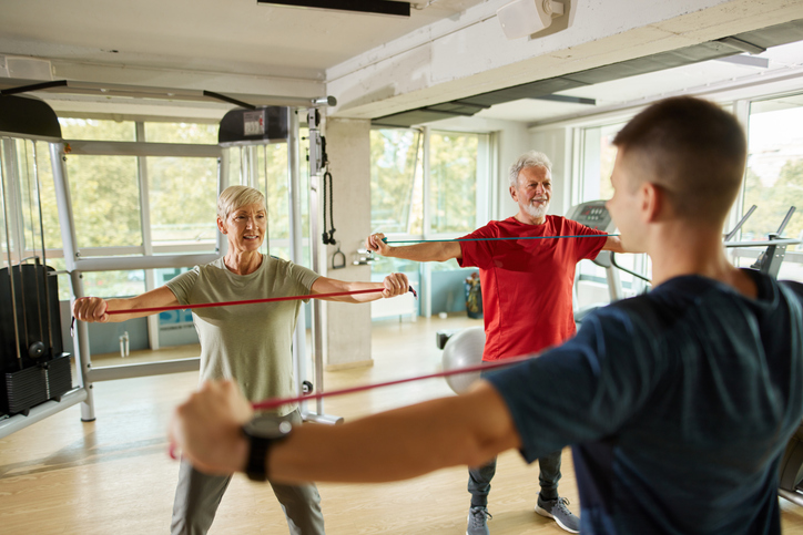 Seniors exercising with resistance bands in a fitness class